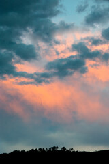 Fototapeta premium Dramatic sunset in rural Guatemala, silhouettes of mountains and colorful sky in clouds of January 2022.