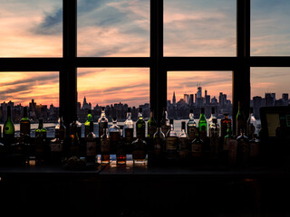 Fototapeta na wymiar New York City skyline at sunset viewed from a bar in Williamsburg on a sunny day in New York City