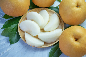 Peeled Snow pear fruit in wooden basket, Fresh Nashi pear or Korean pear fruit in the basket over...