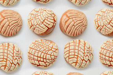 Top view of several Homemade Mexican Conchas. A traditional Mexican sweet bread roll. Round shape and their striped, seashell-like appearance.
