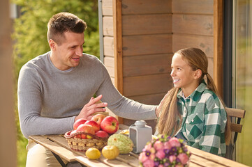 Man talking touching shoulder of interestedly listening daughter