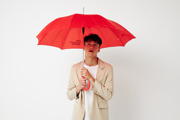 A young man red umbrella a man in a light jacket isolated background unaltered