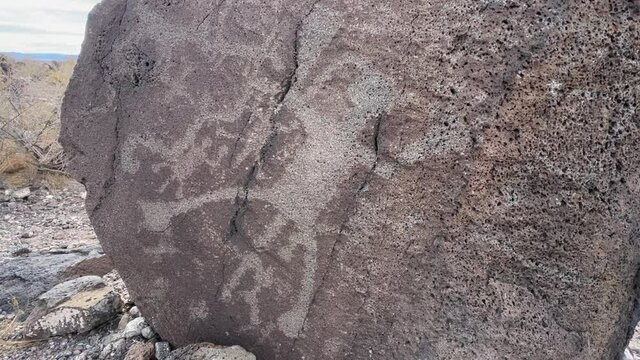 Ancient indigenous petroglyphs on rock in Bandelier National Monument