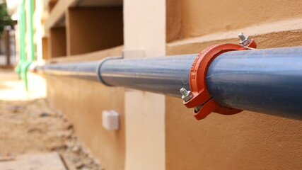 Grooved Coupling on plumbing pipes. Syler plumbing pipe connected with coupling on the side of the...