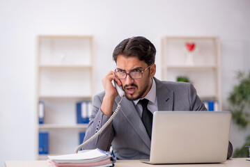 Young male employee working in the office