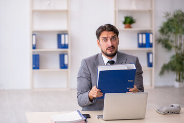 Young male employee working in the office