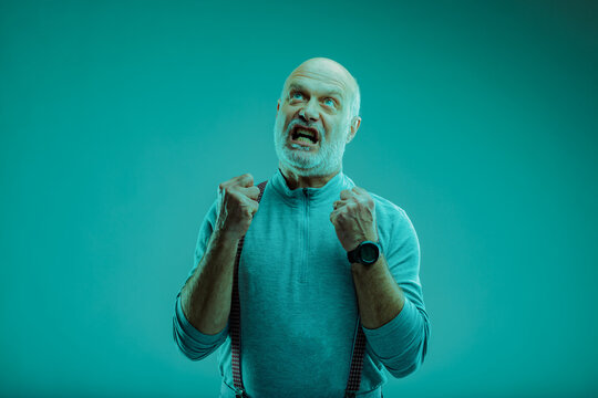 Angry frustrated senior man balling his fists