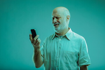 Bemused man looking at his smartphone in confusion