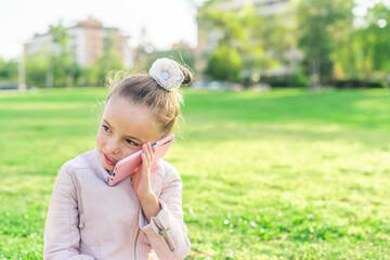 girl looking away talking on phone in the park