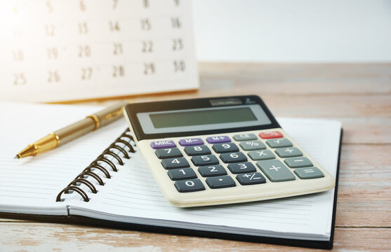 Financial planning, fax, calculator, pen, notebook on the desk.