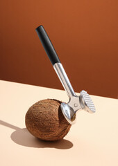 Hammer strikes a ripe coconut. Idea of making cocktail and party.