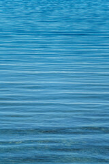 Abstract Background of Blue Water Ripples on a Lake Vertical with Copy Space