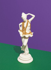long gold chain hangs around the neck statuette of ballerina. Creative inspiration, luxury decoration, trendy design.