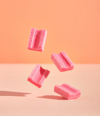 Few pink chewing gums in the air. Sweet fruity youth composition. Positive summer mood. - obrazy, fototapety, plakaty