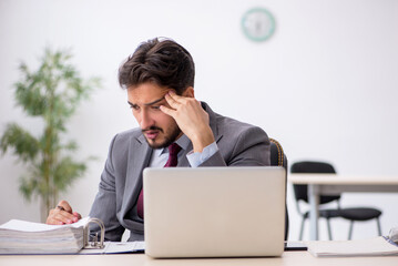 Young male employee working in the office