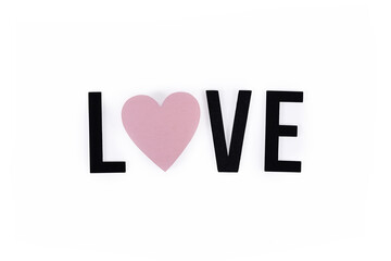Wooden letters and pink heart forming word 'Love' on white background