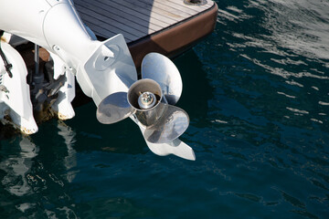 Three-bladed yacht engine propeller with rust spots on it. Shiny metal propeller of yacht engine...