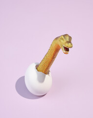 Dinosaur hatches from egg. Creative amazing beauty of wild nature.