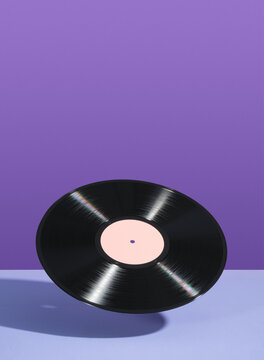 Retro vinyl record float in the air. Copy space for text. Idea of vintage parties and music.