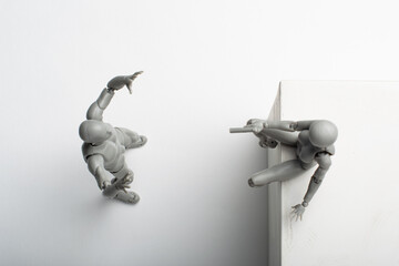 Figurine of a woman aiming a pistol at a male figurine.