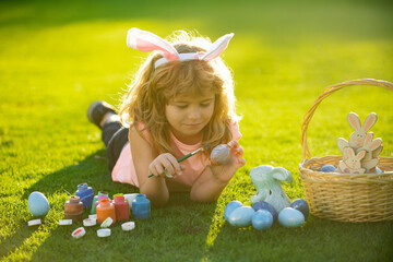 Fototapeta na wymiar Children celebrating easter. Easter kids with bunny ears and on grass background.