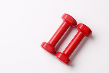 Two red dumbbells isolated on white background