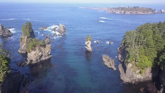 Aerial: Rainforest islands and sea stacks in blue north west Pacific