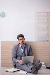 Young male employee working overtime in the office