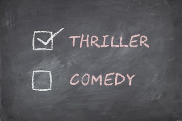 Movie genre preference check box concept on blackboard background. Thriller or comedy.