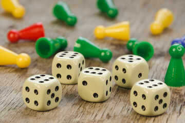 Colorful play figures with group of dice on board