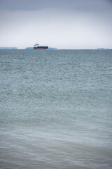 blue sky and calm sea and cargoship in the winter