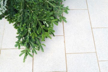 Pine tree brunches on the grey tiles