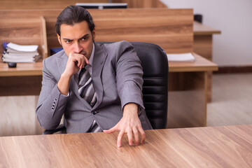 Young businessman employee sitting in the office