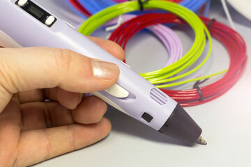 3 d pen in a woman's hand, hobby construction