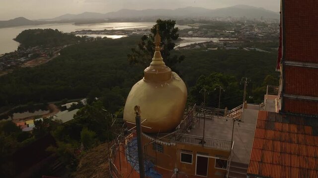 The replica of Phra That In-Kwaen (Hanging Golden Rock) with Sunset background, Sirey temple, Phuket, Thailand.