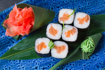 Fresh sushi dish on a blue plate.