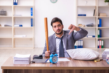 Young male employee in oversleeping concept