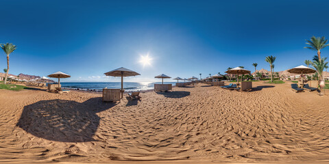 full seamless spherical hdr 360 panorama view on coast of sea with wooden beach umbrellas and sun...