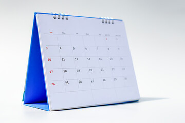 White desk calendar on dark wooden table, planning concept.	