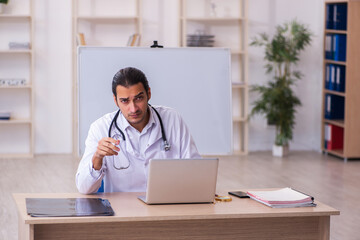 Young male doctor in telemedicine concept