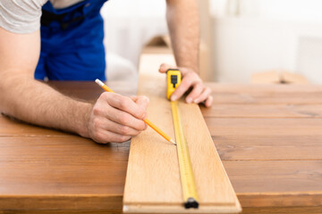 Unrecognizable Carpenter Measuring Wooden Board Making Furniture Indoor