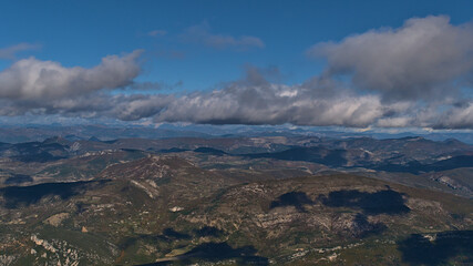 Beautiful panoramic view of subalpine mountain range Baronnies viewed from the top of popular Mont Ventoux in Provence region, France on sunny day.