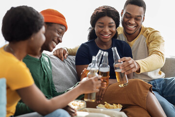 Group of black friends enjoying drinks party at home