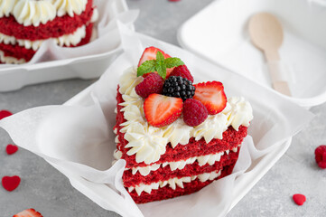 Red velvet bento cake. A small cake in a lunchbox on a gray concrete background. Valentine's Day Cake. Asian food trend. Cute gift for any holiday. Copy space.