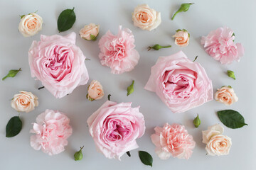 Beautiful flowers on a light gray background, roses, carnations, buds and greenery. Top view, copy space.
Floral background, greeting card.