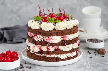 Naked Black forest cake, Schwarzwald pie. Cake with dark chocolate, whipped cream and cherry on a...