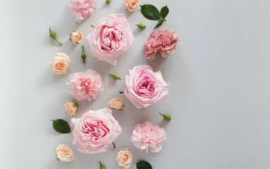 Beautiful flowers on a light gray background, roses, carnations, buds and greenery. Top view, copy space.
Floral background, greeting card.