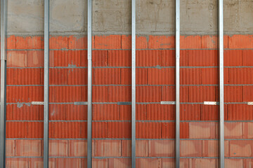 Work in progress on a construction site for a residential building. Brick wall and metal mounting...