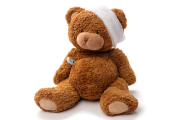 medicine, healthcare and childhood concept - teddy bear toy with bandaged head and thermometer on white background
