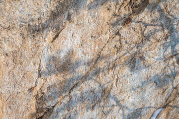 Detail of stone texture for background. Surface of the marble with brown tint